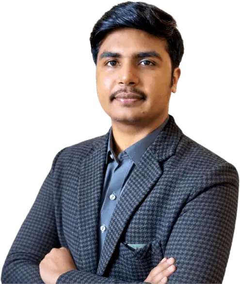 Zain Ismail in a checkered suit and grey shirt standing confidently against a green background.